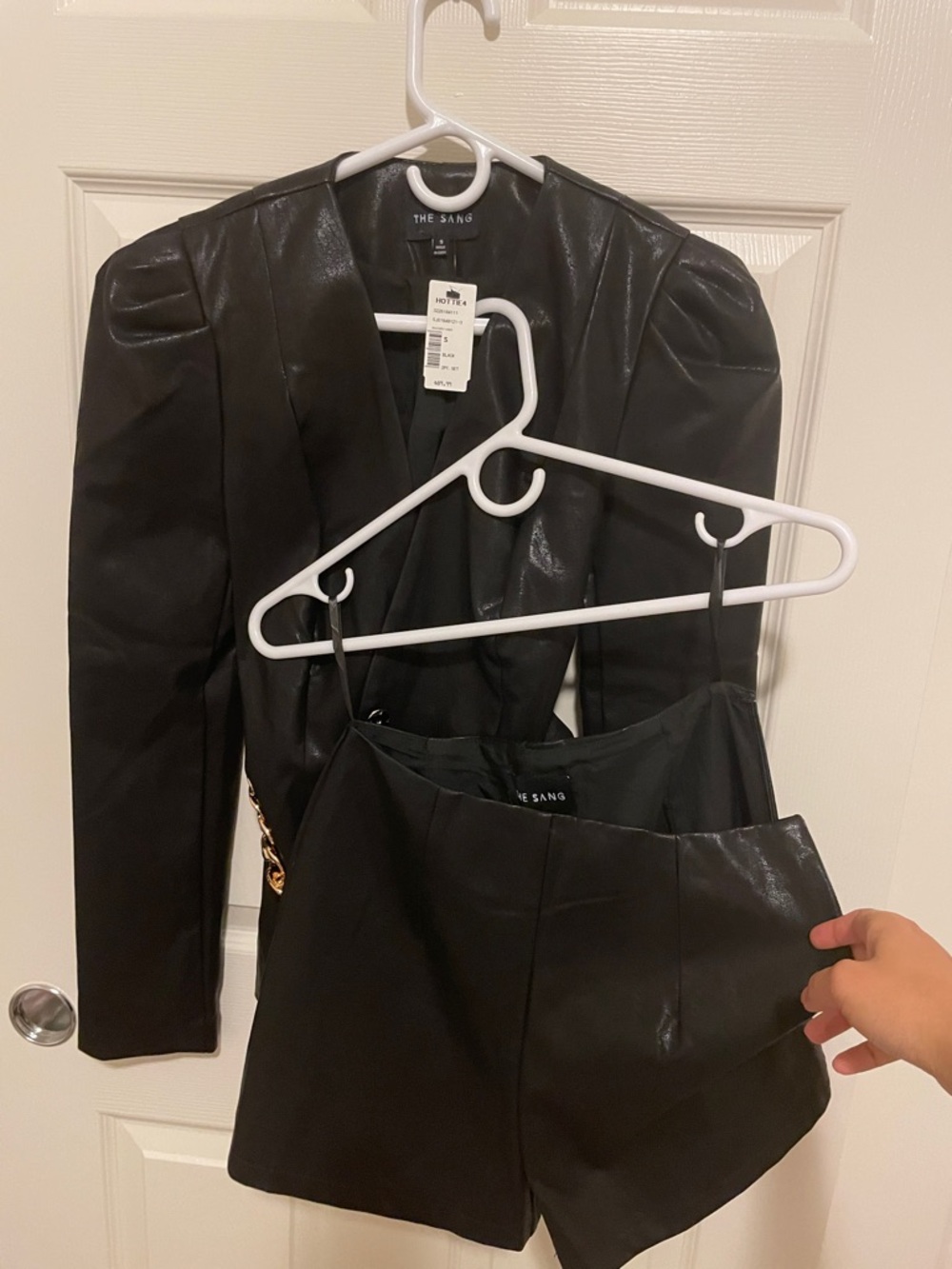The Sand Black Faux Leather Puff-Sleeve Blazer with Gold Chain Belt with shorts